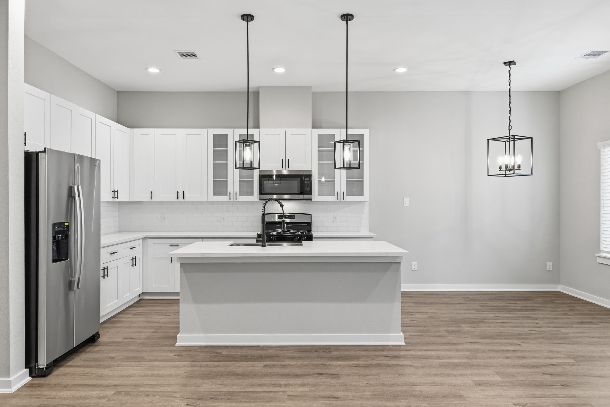 412 Stonework Landing Lane Houston, TX 77076 - Photo 7 of 30 a view of kitchen with stainless steel appliances granite countertop cabinets and wooden floor