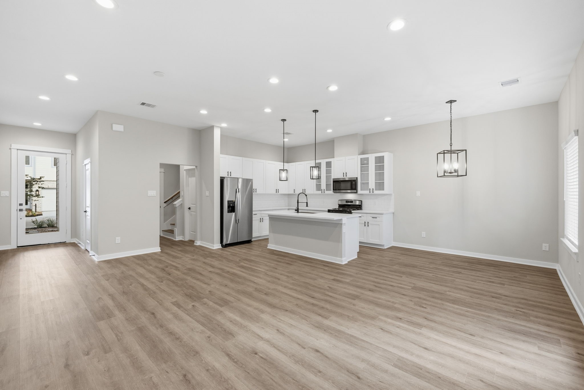 412 Stonework Landing Lane Houston, TX 77076 - Photo 8 of 30 a view of kitchen with kitchen island wooden floors appliances and cabinets