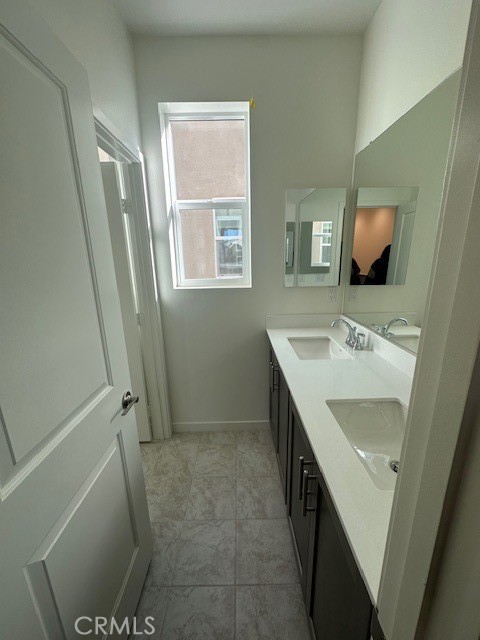 32703 Brunello Way Temecula, CA 92591 - Photo 11 of 26 a bathroom with a sink a toilet and a mirror