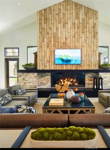 a dining room with furniture and a large window