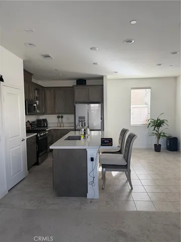 a living room with furniture and kitchen