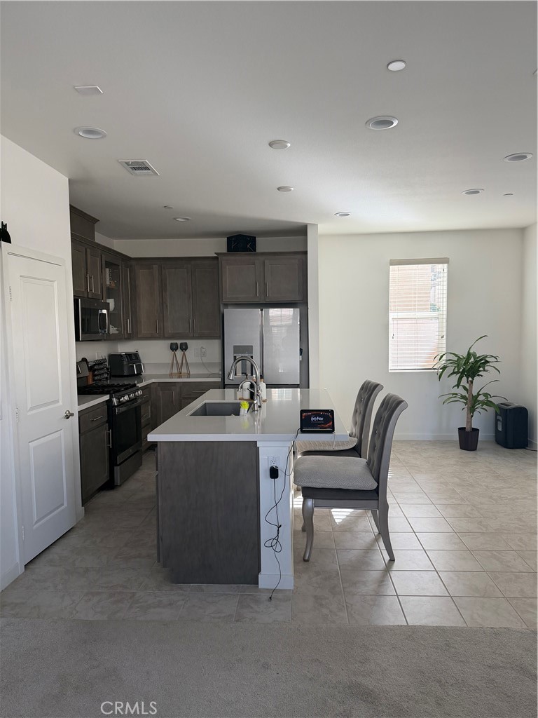 32703 Brunello Way Temecula, CA 92591 - Photo 4 of 26 a living room with furniture and kitchen
