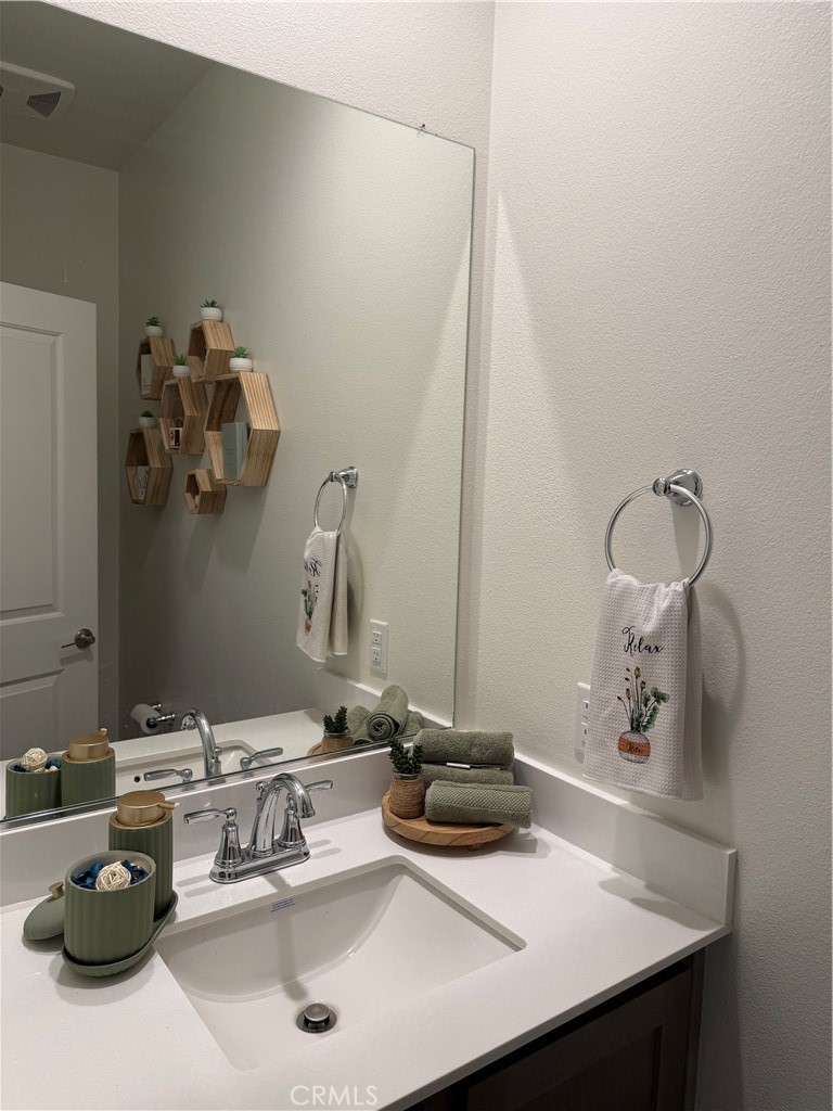 32703 Brunello Way Temecula, CA 92591 - Photo 10 of 26 a bathroom with a sink and a mirror