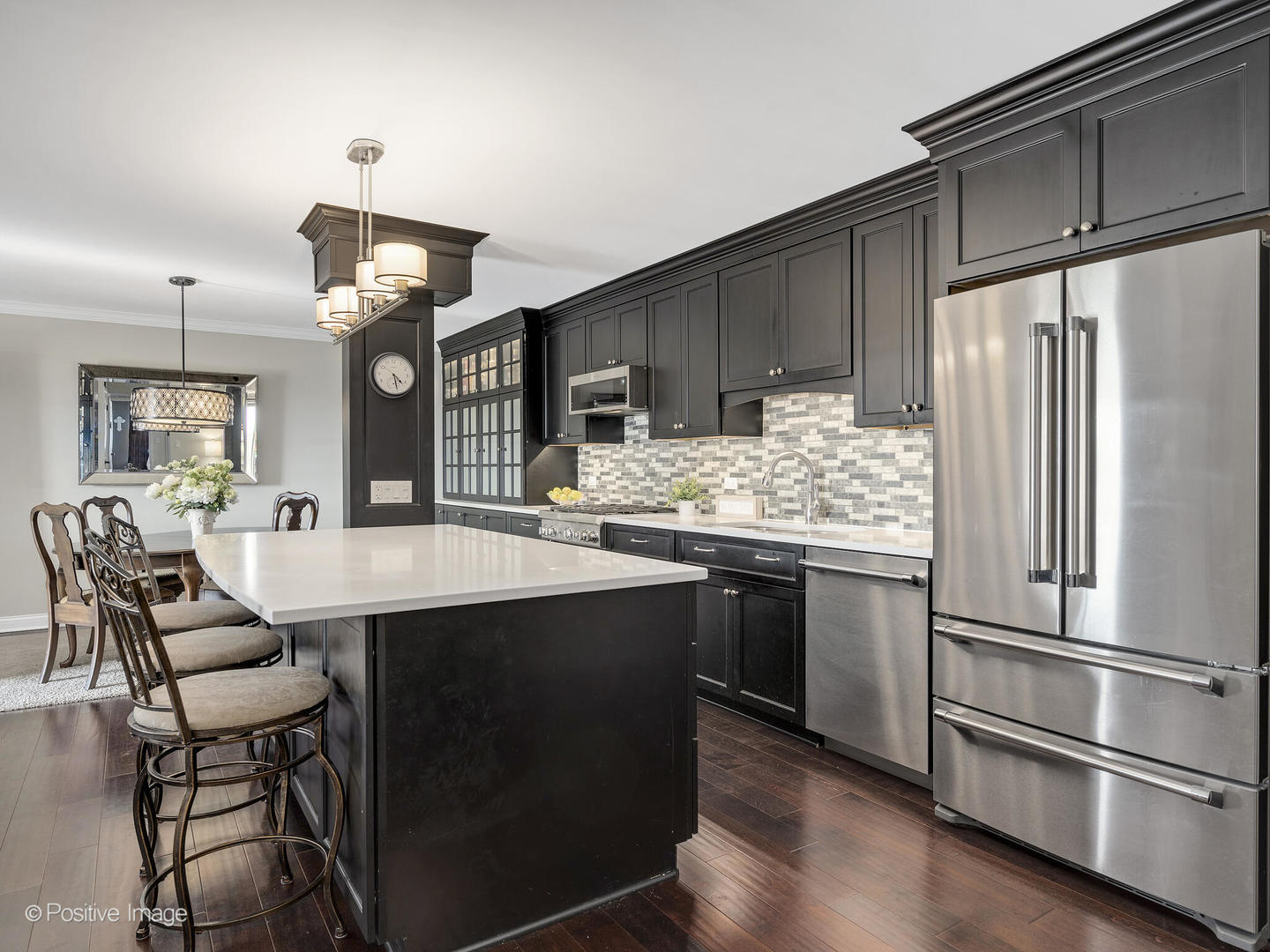 100 West Butterfield Road, Unit 401N Elmhurst, IL 60126 - Photo 15 of 29 a kitchen with stainless steel appliances kitchen island granite countertop a table chairs and a refrigerator