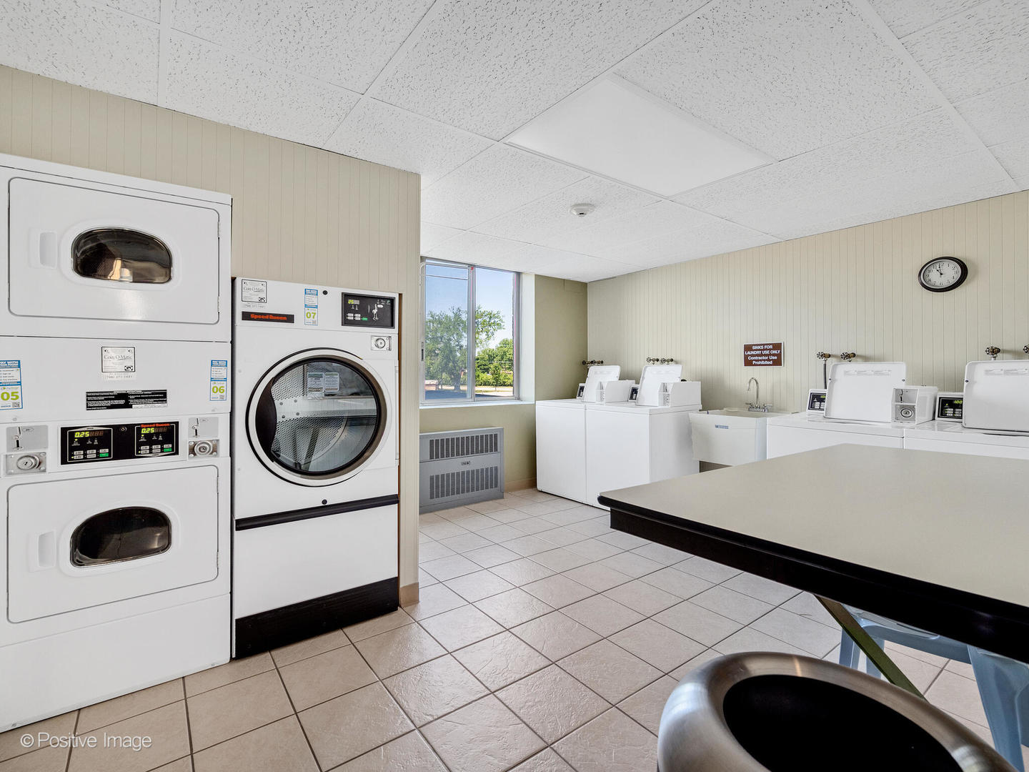 100 West Butterfield Road, Unit 401N Elmhurst, IL 60126 - Photo 28 of 29 a room with a washing machine and a washing machine with racks