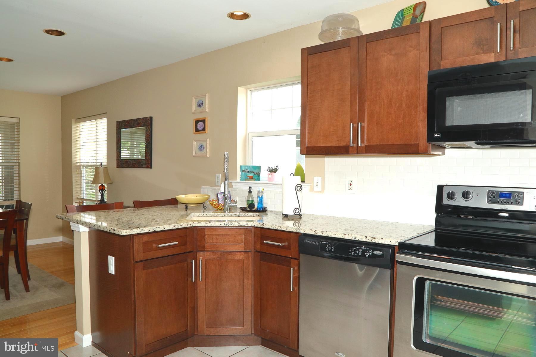 1049 Kent Garden Lititz, PA 17543 - Photo 15 of 29 a kitchen with stainless steel appliances granite countertop a stove a sink and a microwave