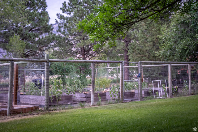435 Canyon Road Millville, UT 84326 - Photo 63 of 113 Fenced garden area featuring multiple raised wooden planter beds