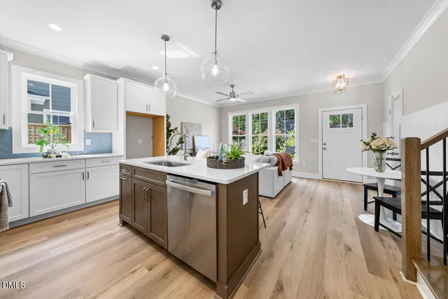 a kitchen with stainless steel appliances granite countertop a stove and cabinets
