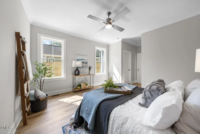 a bedroom with a bed and wooden floor