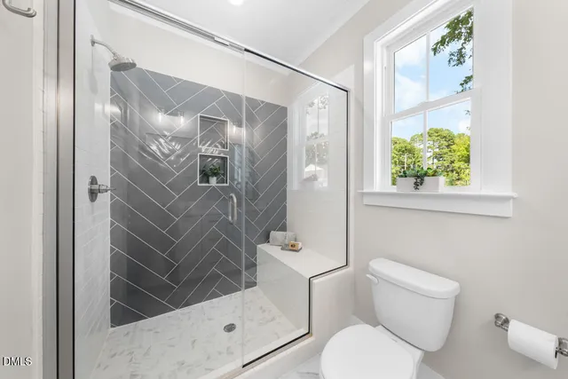 a bathroom with a toilet and a shower