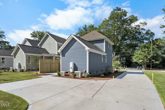 a front view of house with yard and trees around