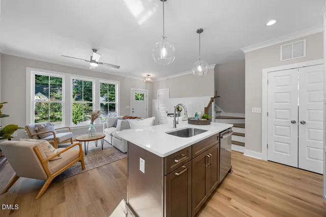 a kitchen with a stove and a wooden floor