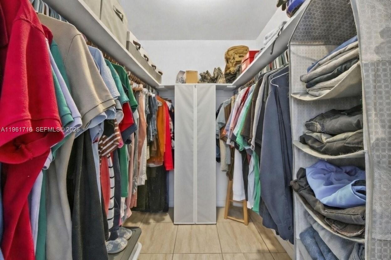 1916 North 36th Avenue Hollywood, FL 33021 - Photo 13 of 22 a view of walk in closet with clothes and shoes