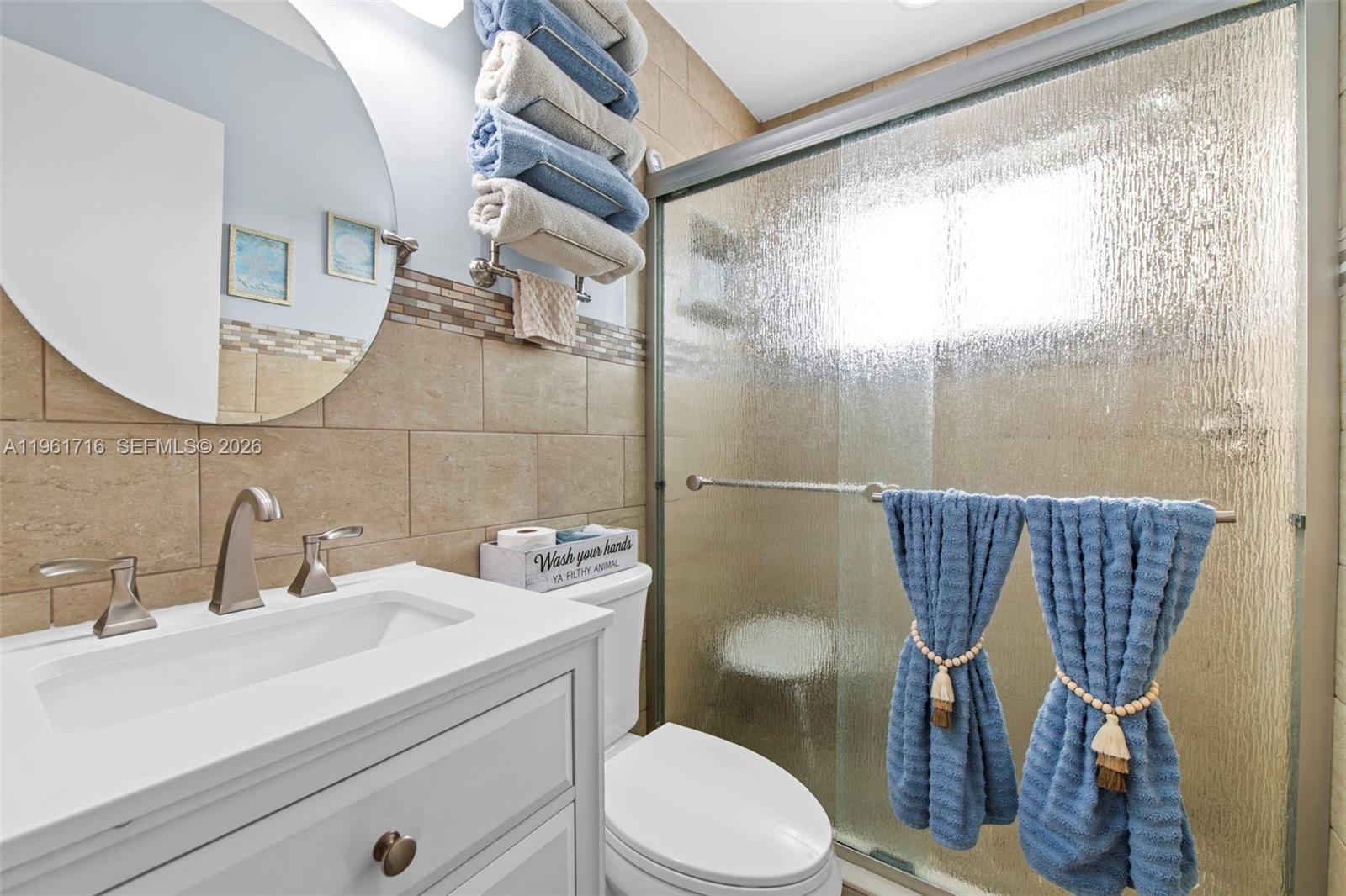1916 North 36th Avenue Hollywood, FL 33021 - Photo 14 of 22 a bathroom with a sink mirror vanity and toilet