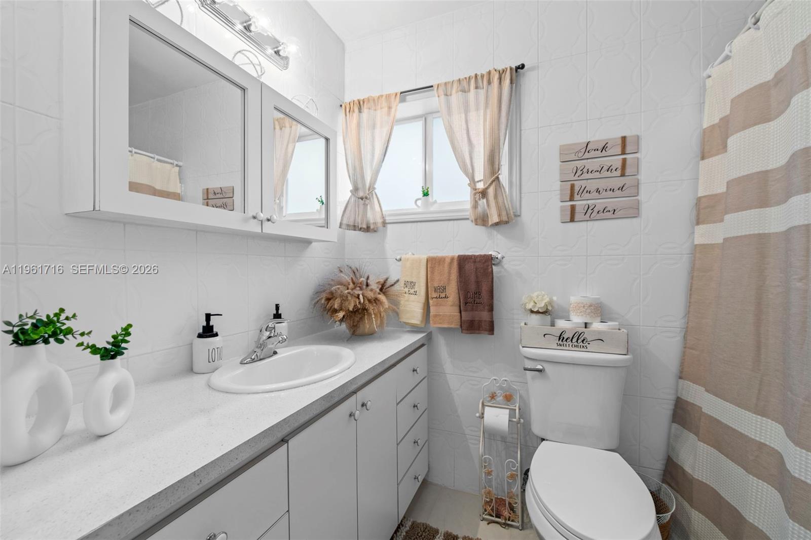 1916 North 36th Avenue Hollywood, FL 33021 - Photo 18 of 22 a bathroom with a sink a toilet and a mirror