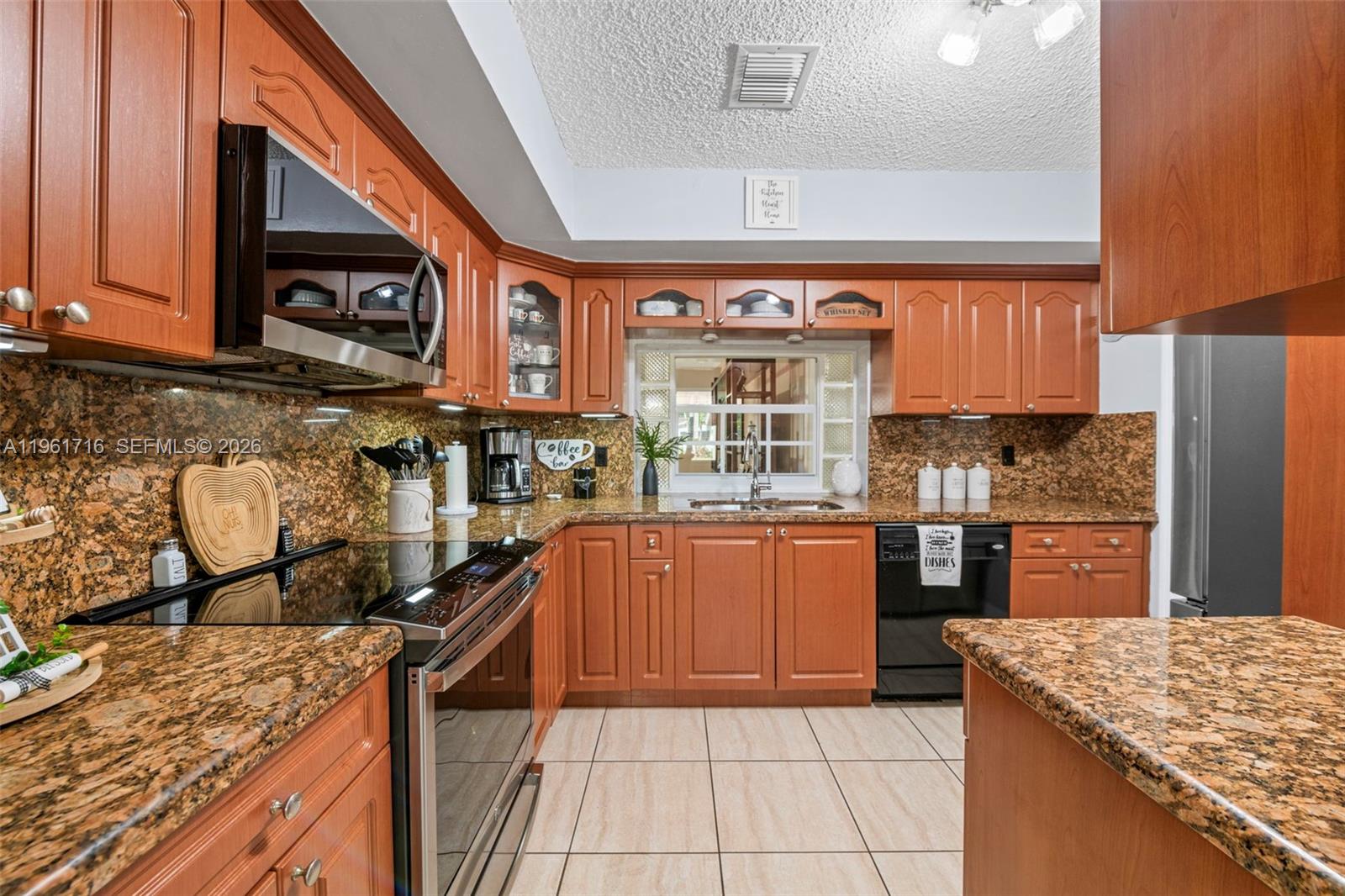 1916 North 36th Avenue Hollywood, FL 33021 - Photo 6 of 22 a kitchen with stainless steel appliances granite countertop a stove a sink and a microwave