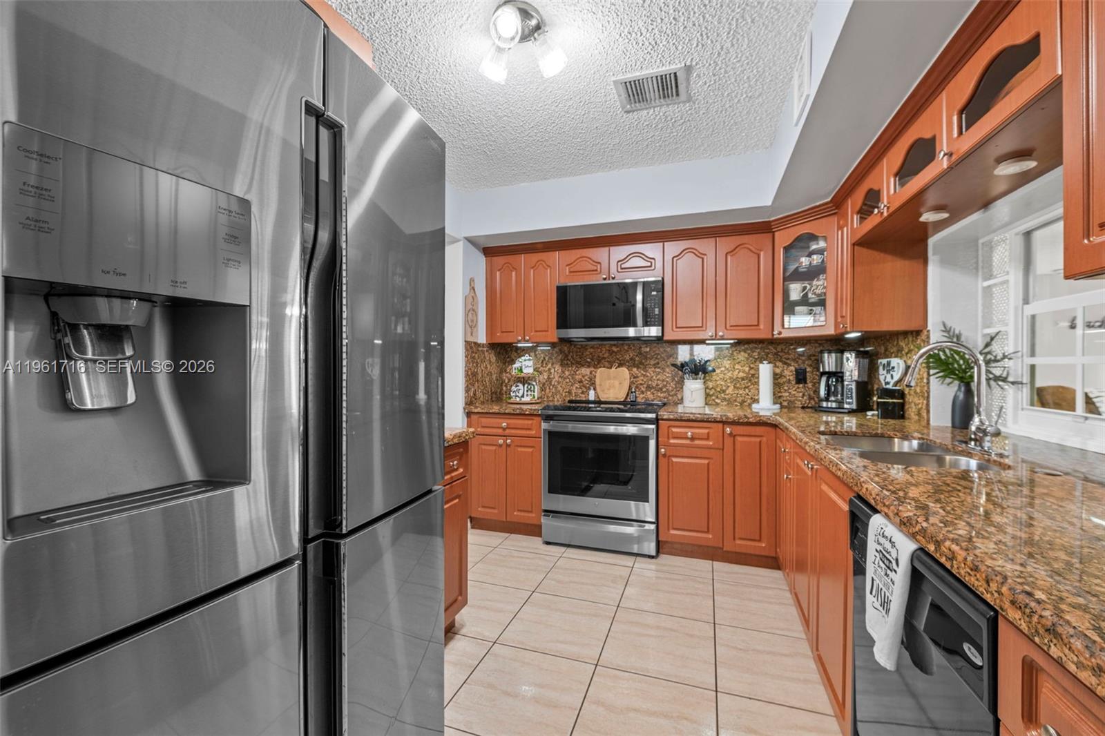 1916 North 36th Avenue Hollywood, FL 33021 - Photo 7 of 22 a kitchen with stainless steel appliances granite countertop a refrigerator a stove and a sink