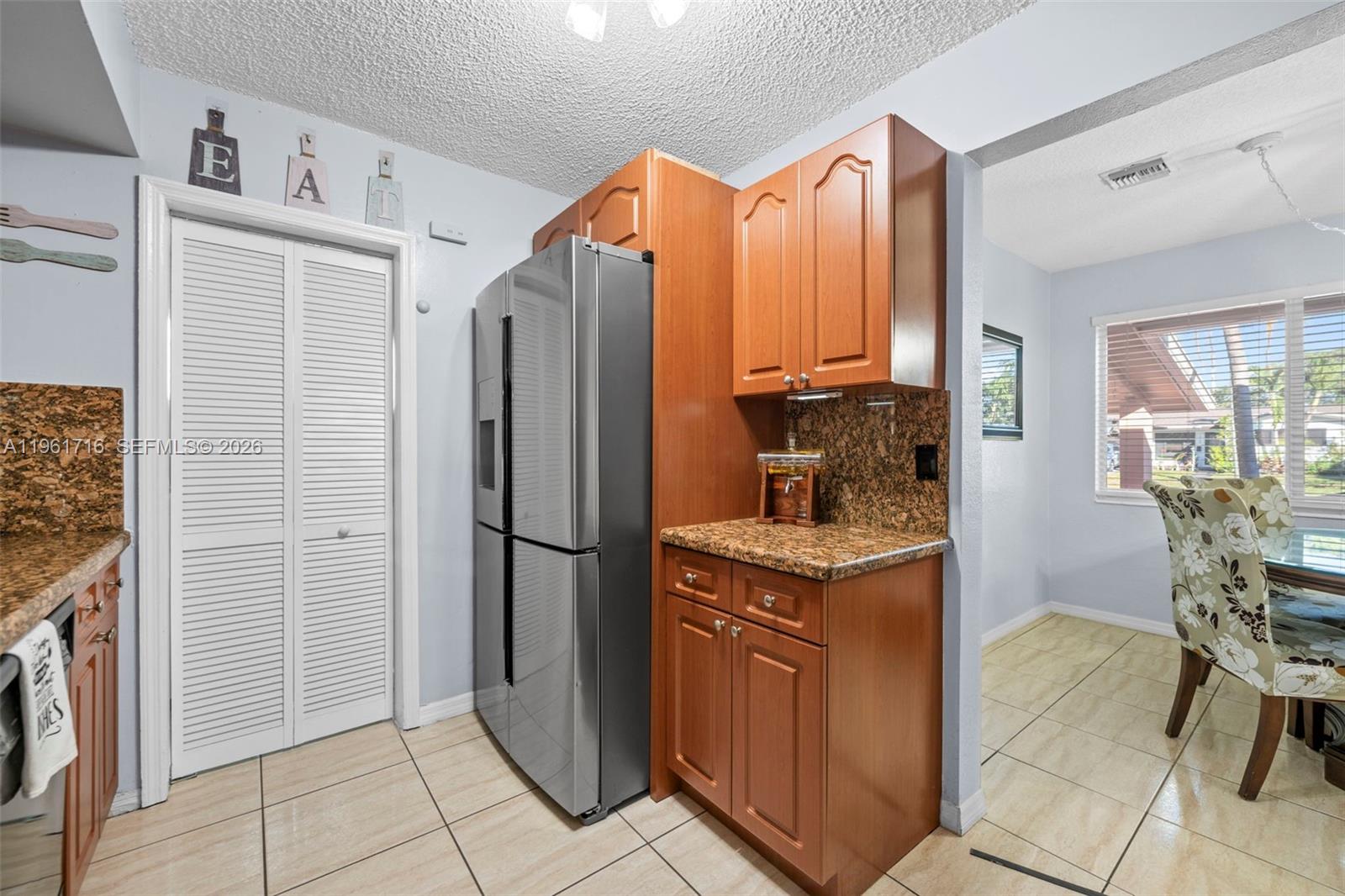 1916 North 36th Avenue Hollywood, FL 33021 - Photo 8 of 22 a kitchen with stainless steel appliances granite countertop a refrigerator and a stove