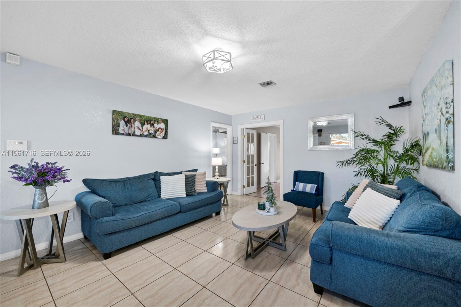 1916 North 36th Avenue Hollywood, FL 33021 - Photo 9 of 22 a living room with furniture and a chandelier