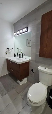 a white toilet sitting next to a bathroom sink