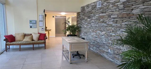 a building outdoor space with patio furniture and potted plants