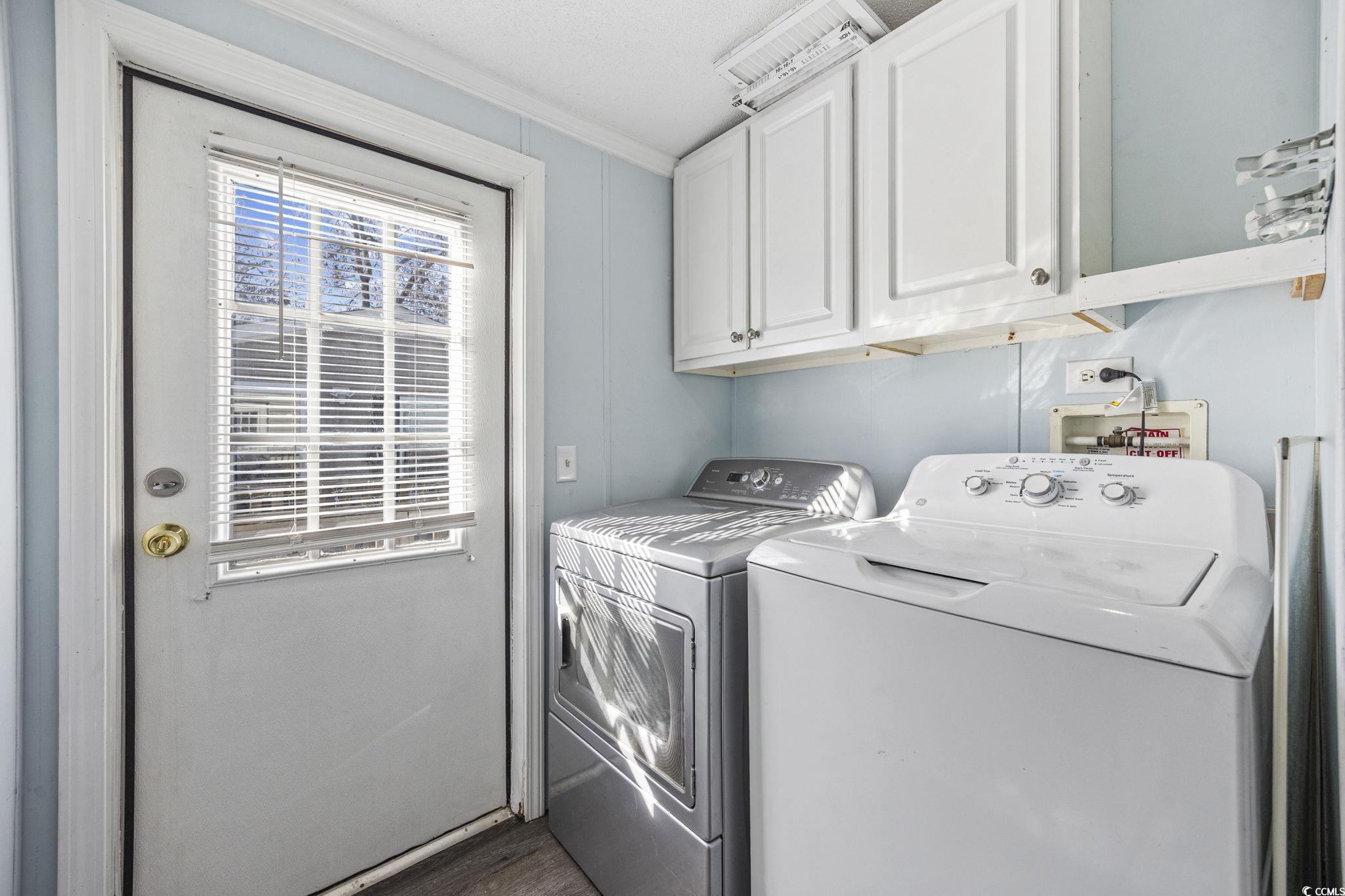 2000 Highway 15 Myrtle Beach, SC 29577 - Photo 11 of 27 Laundry room featuring cabinet space, crown molding, and independent washer and dryer