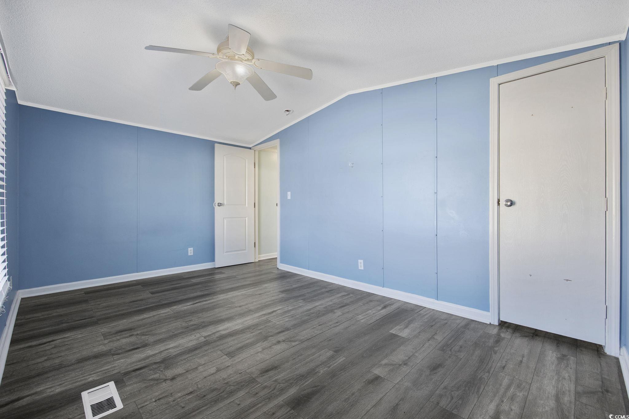 2000 Highway 15 Myrtle Beach, SC 29577 - Photo 19 of 27 Unfurnished bedroom with dark wood finished floors, ceiling fan, and vaulted ceiling