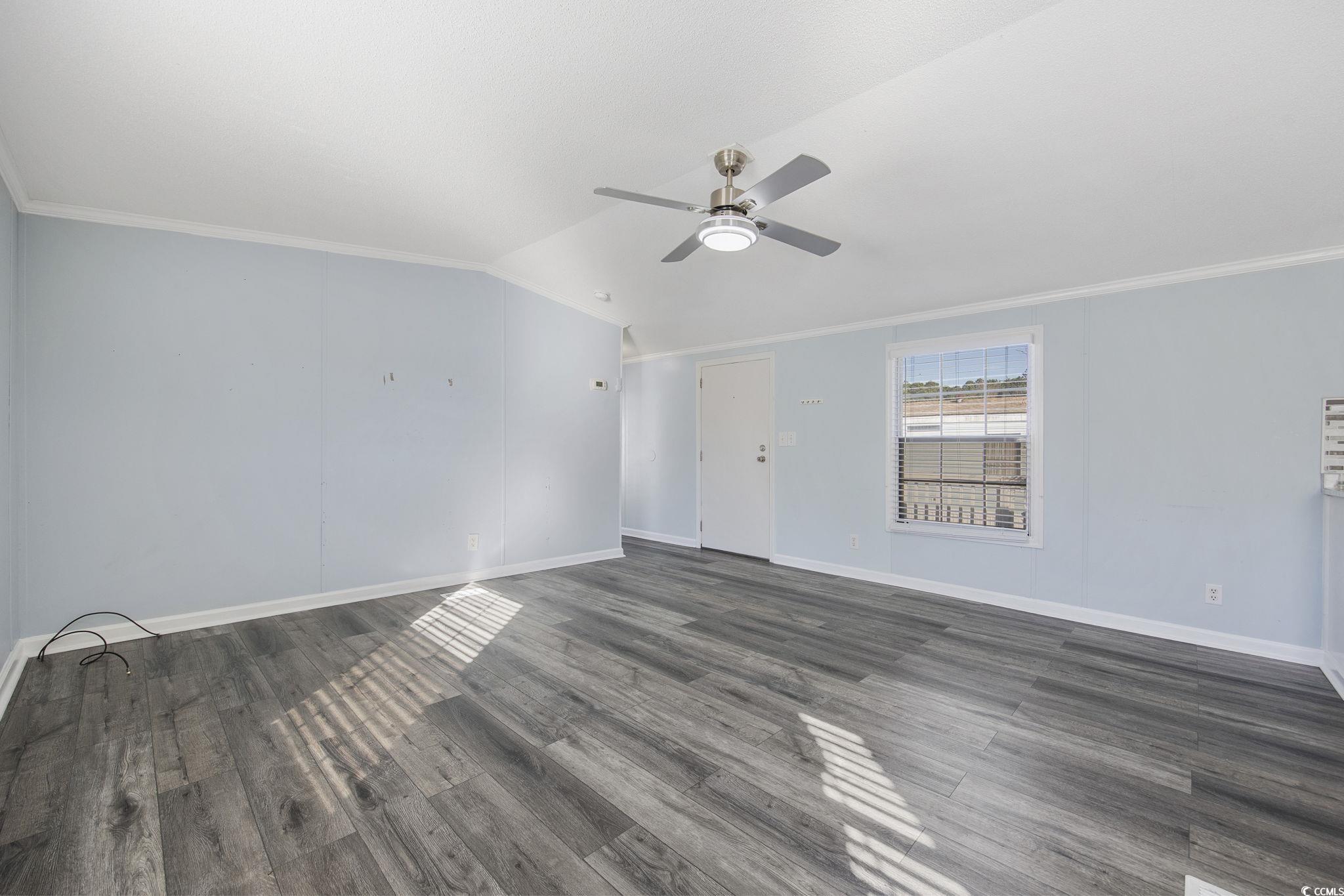 2000 Highway 15 Myrtle Beach, SC 29577 - Photo 4 of 27 Spare room with ornamental molding, dark wood finished floors, and lofted ceiling