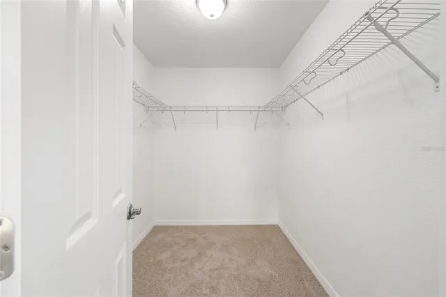 an empty room with chandelier fan