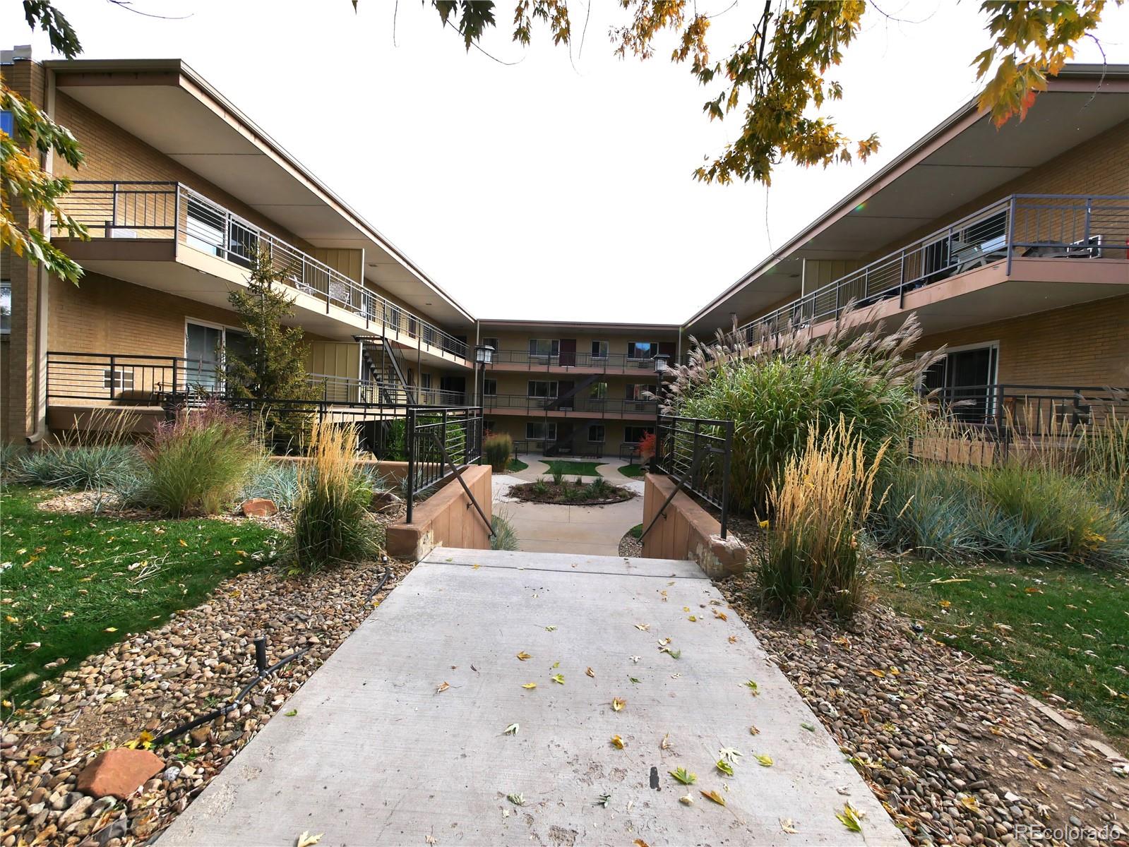 830 20th Street, Unit 303 Boulder, CO 80302 - Photo 1 of 28 a front view of a house with a yard