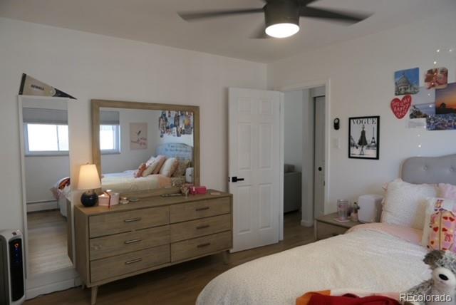 830 20th Street, Unit 303 Boulder, CO 80302 - Photo 12 of 28 a bedroom with a bed and wooden floor