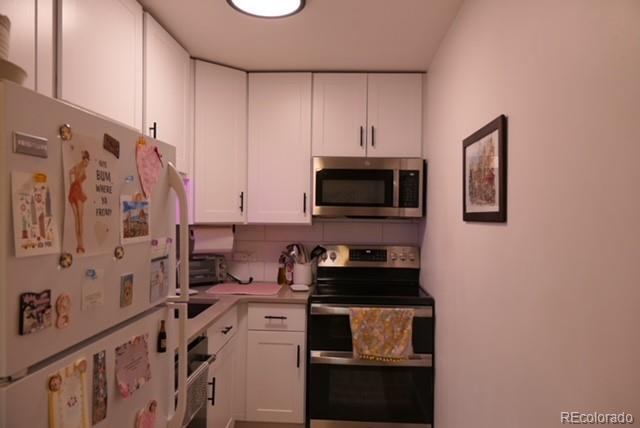 830 20th Street, Unit 303 Boulder, CO 80302 - Photo 19 of 28 a kitchen with stainless steel appliances a stove a microwave and cabinets