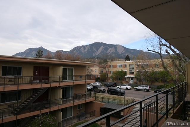 830 20th Street, Unit 303 Boulder, CO 80302 - Photo 25 of 28 a view of a balcony with two chairs and a table