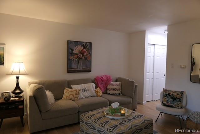 830 20th Street, Unit 303 Boulder, CO 80302 - Photo 3 of 28 a living room with furniture and a lamp