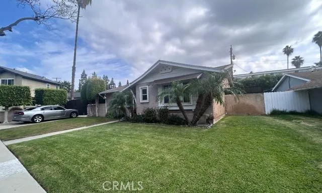 a view of a house with a patio and a yard