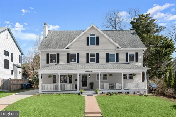 a front view of a house with a garden and plants