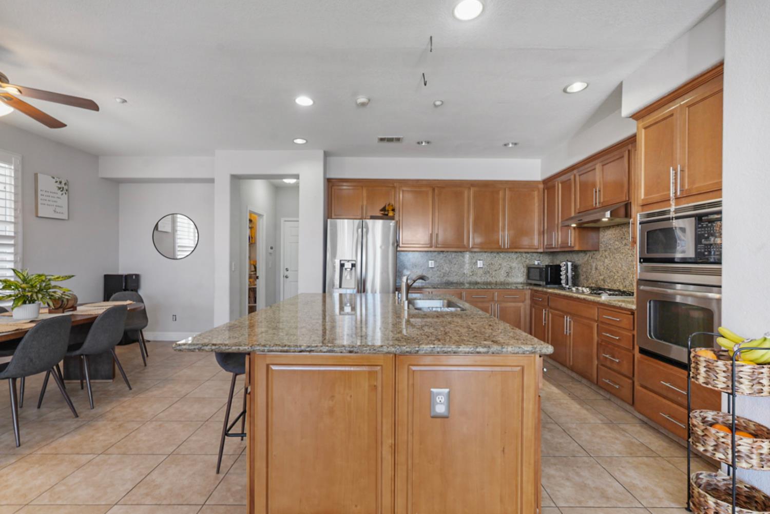 16501 Upper Pasture Lathrop, CA 95330 - Photo 16 of 41 a kitchen with stainless steel appliances granite countertop a refrigerator and a stove top oven