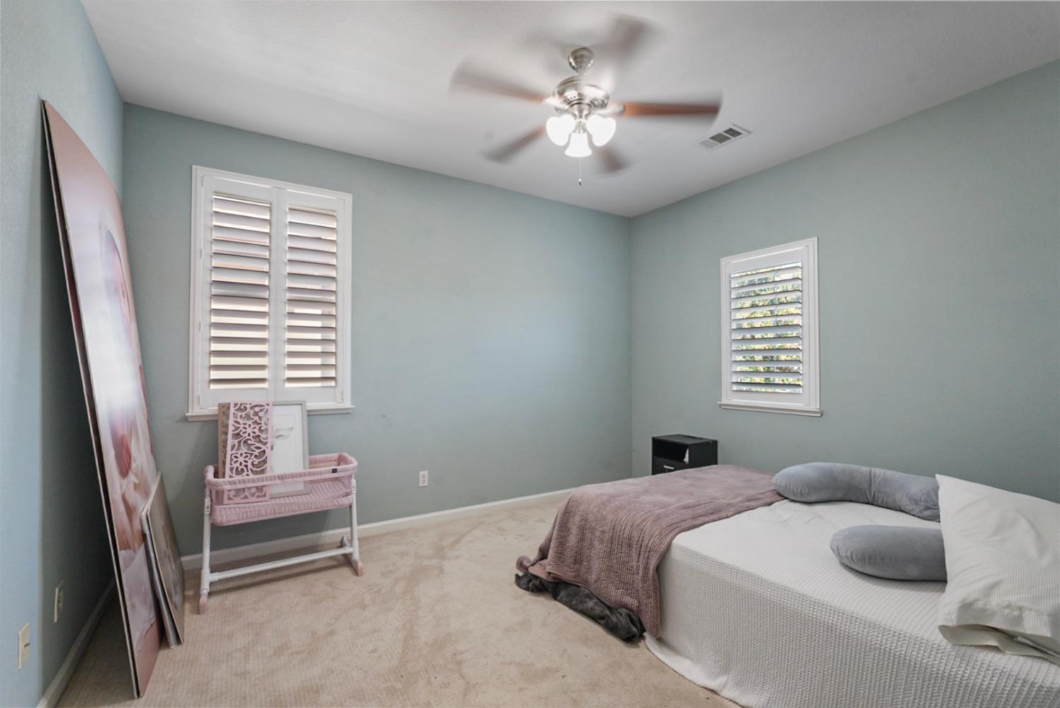 16501 Upper Pasture Lathrop, CA 95330 - Photo 23 of 41 a bedroom with a bed and a chandelier