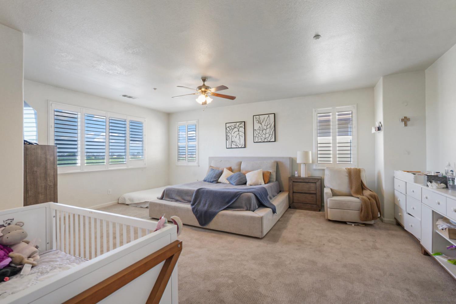 16501 Upper Pasture Lathrop, CA 95330 - Photo 25 of 41 a spacious bedroom with two beds and a chandelier