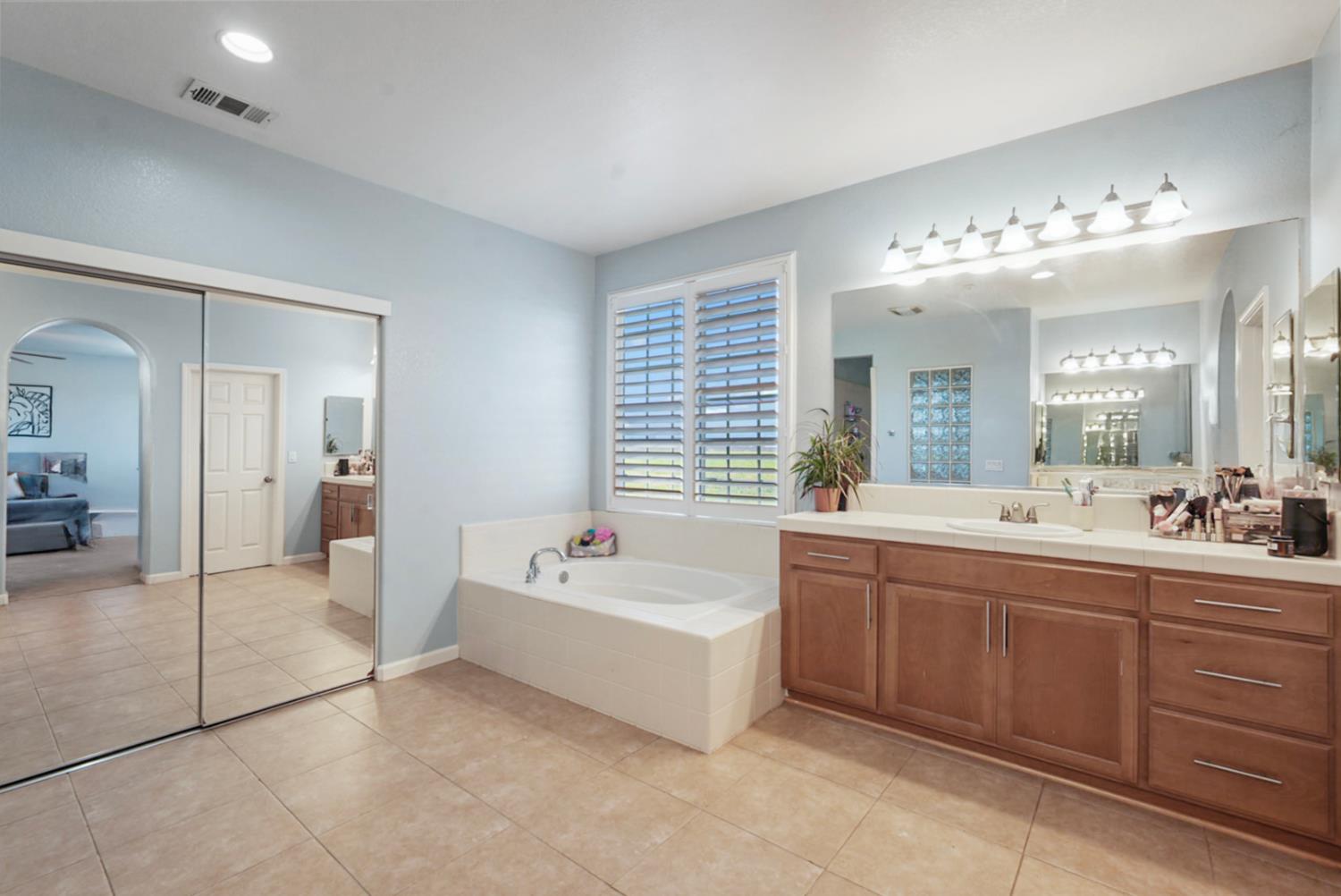 16501 Upper Pasture Lathrop, CA 95330 - Photo 27 of 41 a spacious bathroom with a tub sink shower and mirror