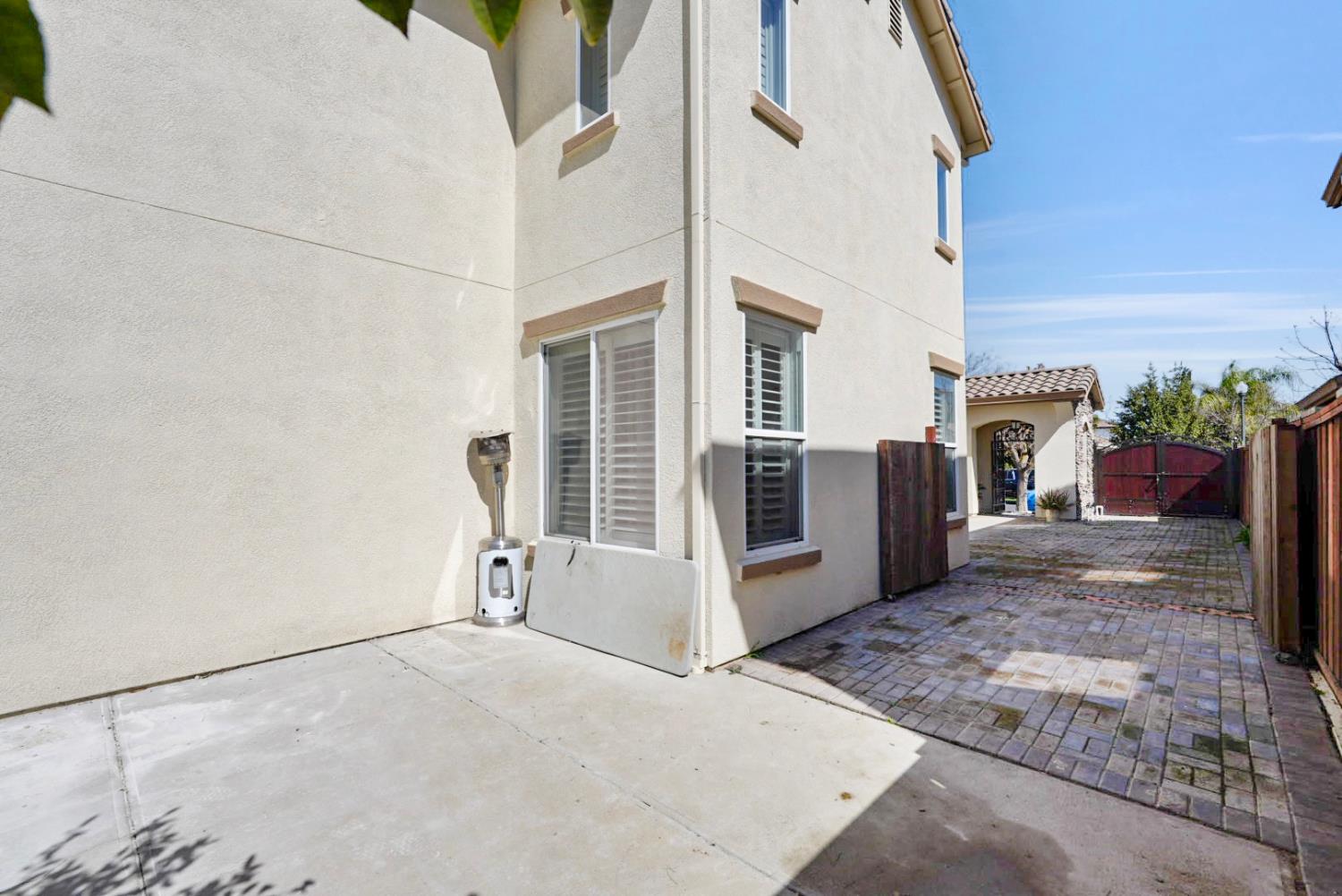 16501 Upper Pasture Lathrop, CA 95330 - Photo 32 of 41 a view of a white house with a large parking space