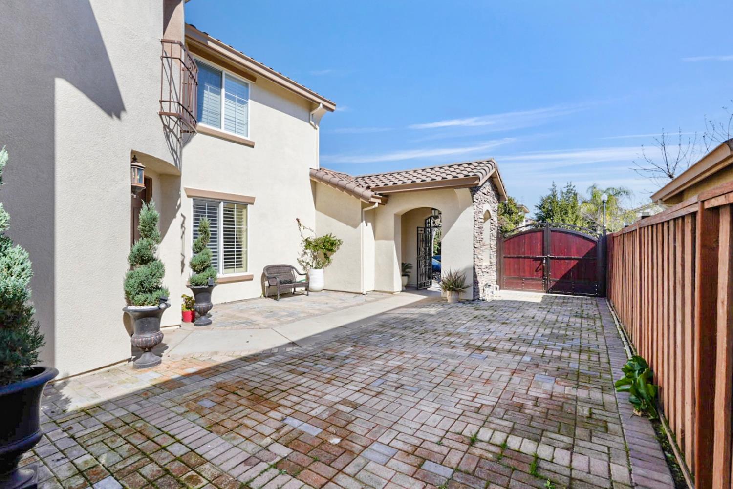 16501 Upper Pasture Lathrop, CA 95330 - Photo 33 of 41 a view of a house with a yard and potted plants