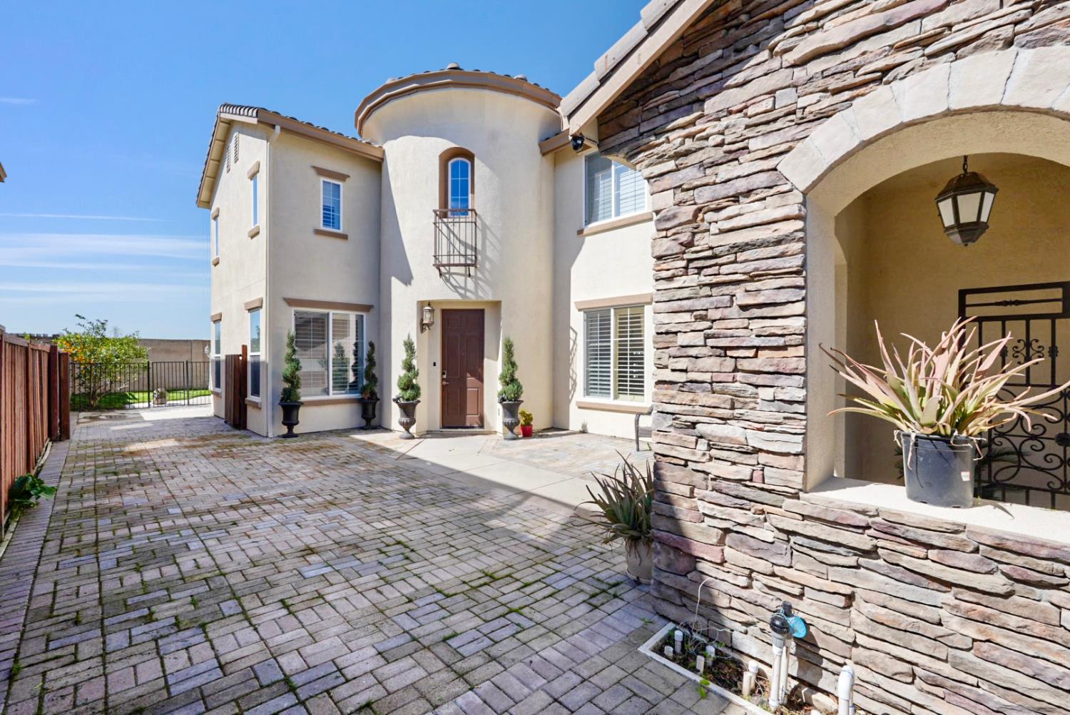 16501 Upper Pasture Lathrop, CA 95330 - Photo 4 of 41 a front view of a house with a yard