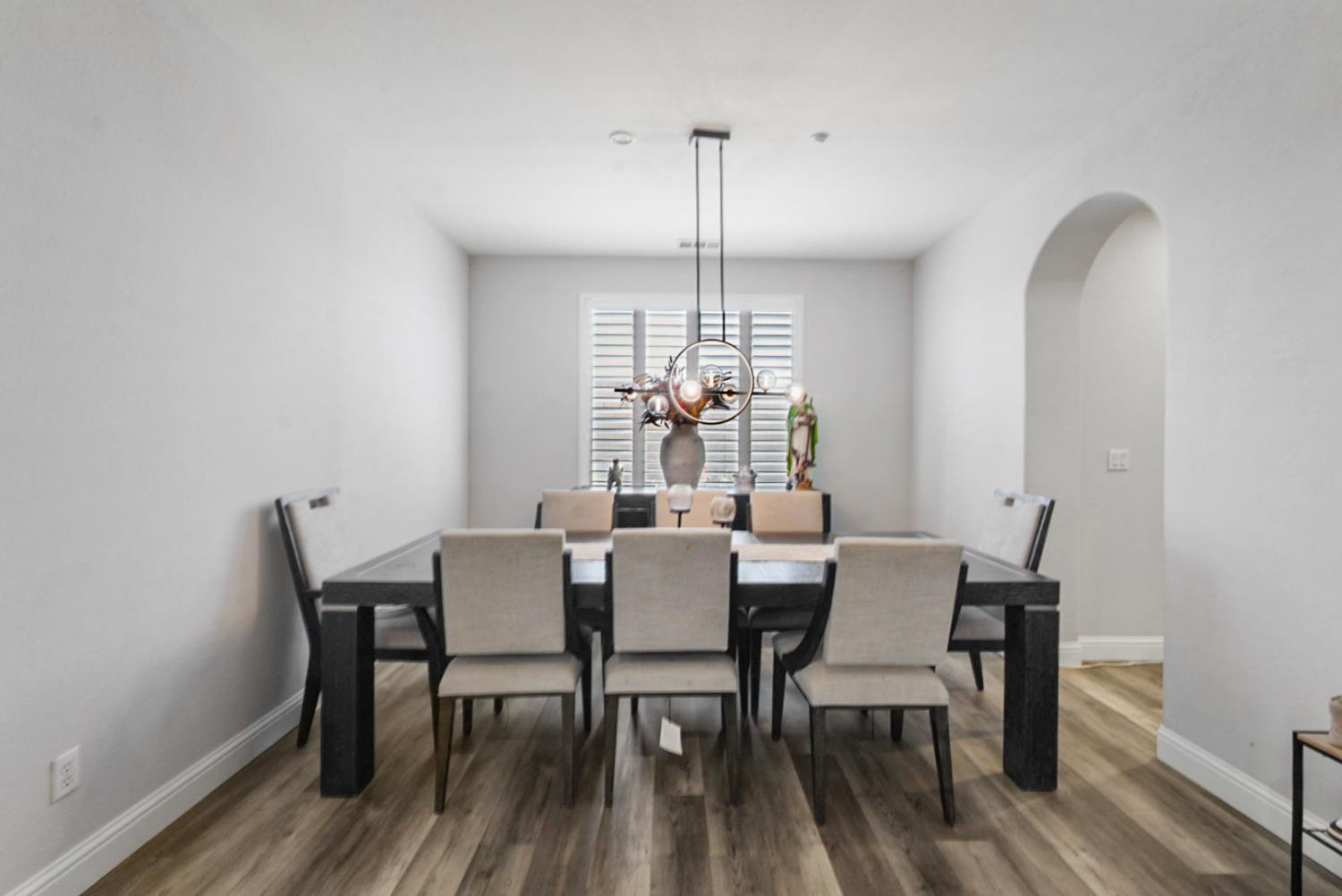 16501 Upper Pasture Lathrop, CA 95330 - Photo 10 of 41 a view of a dining room with furniture window and wooden floor