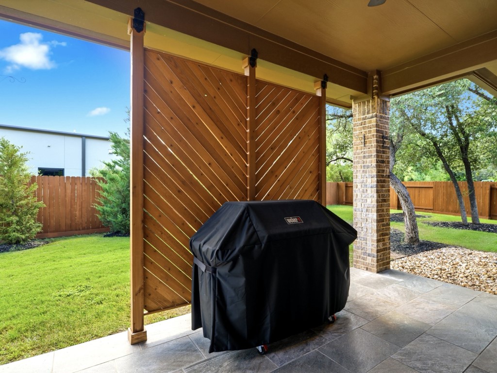 109 Lake Spring Circle Georgetown, TX 78633 - Photo 34 of 38 A private covered patio with ample space for outdoor cooking and relaxation.