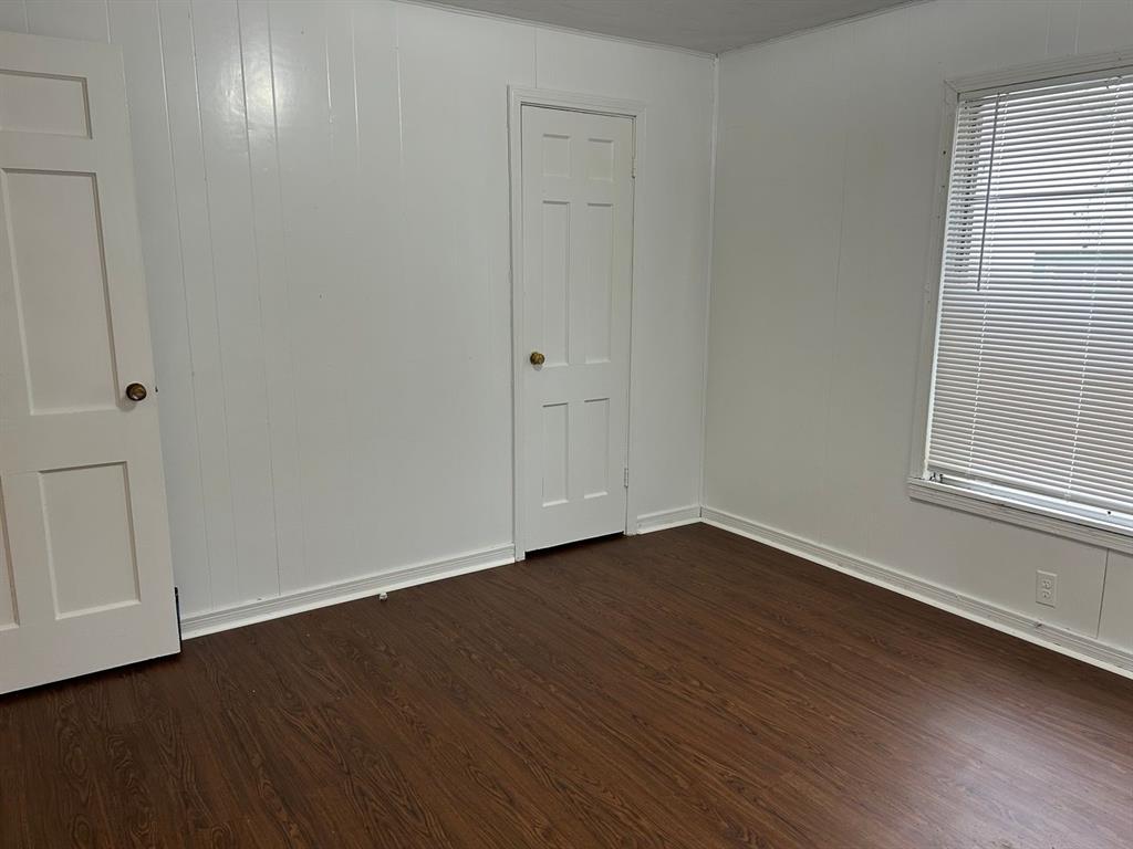 1411 James Street Sweetwater, TX 79556 - Photo 2 of 10 a view of an empty room with wooden floor and a window