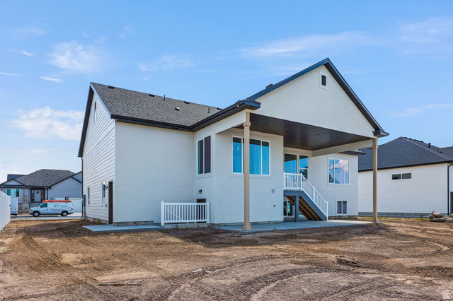 1144 South 4475 West West Point, UT 84015 - Photo 29 of 30 Rear exterior featuring a covered patio, multiple windows, and an exterior staircase with white railings