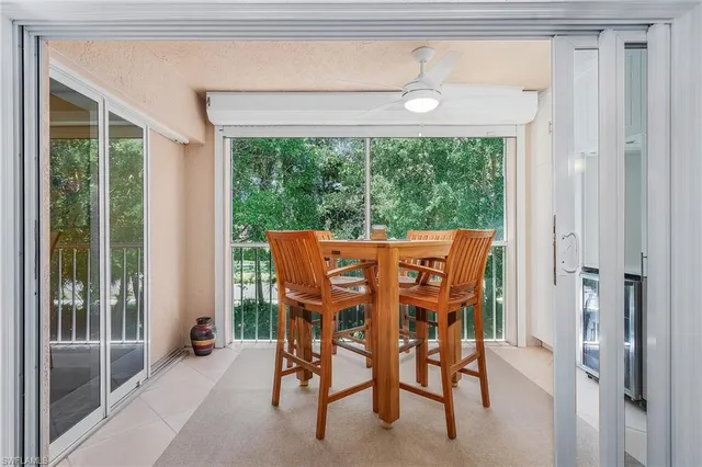 a view of a dining room with furniture large windows and wooden floor