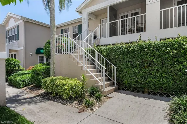 a view of a house with brick walls and flower plants