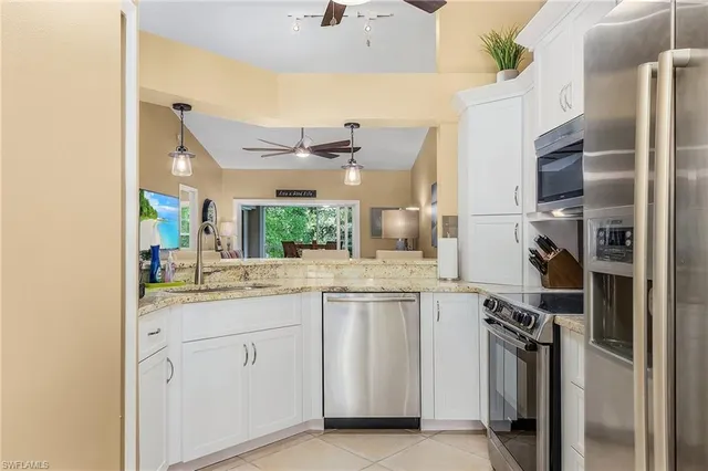 a kitchen with a sink stainless steel appliances and cabinets